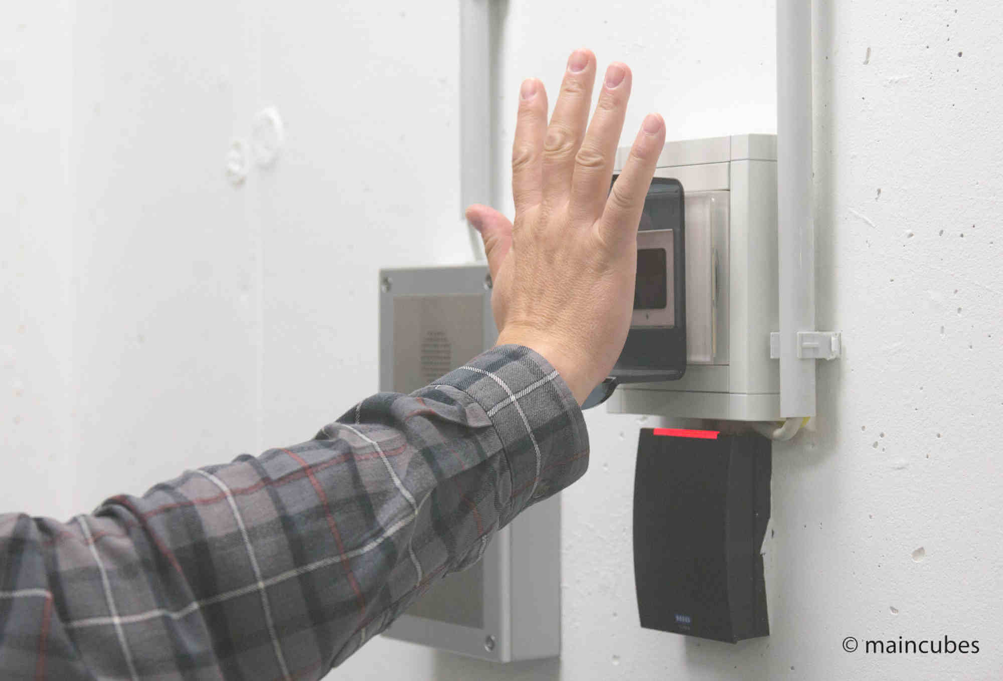 Hand resting on a vein scanner in a security gate